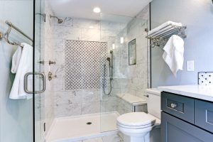 amazing bathroom with walk in shower and gray vanity - bathroom remodeling by top home builders