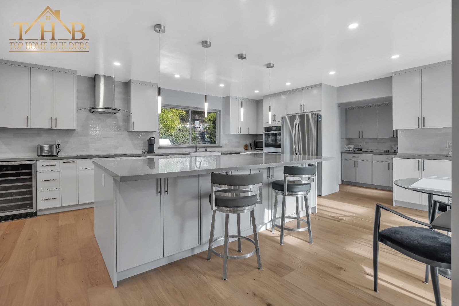 White kitchen island and dining area after renovation